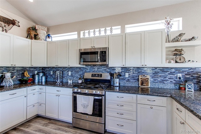 18050 Wedemeyer Rd, Kiowa, CO 80117 - kitchen with stainless steel appliances, open shelves, decorative backsplash, light wood finished floors, and dark stone counters