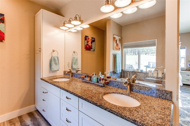 18050 Wedemeyer Rd, Kiowa, CO 80117 - bathroom with double vanity, wood finished floors, and baseboards