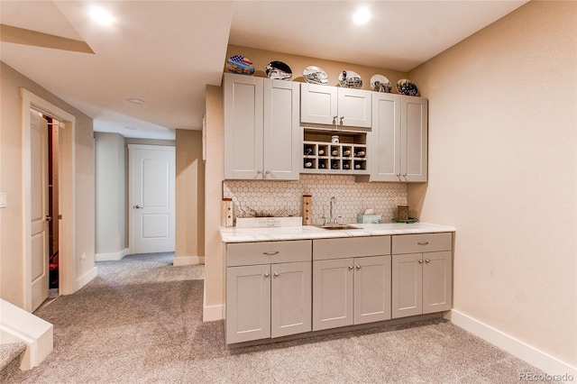 18050 Wedemeyer Rd, Kiowa, CO 80117 - kitchen with light carpet, a sink, baseboards, tasteful backsplash, and gray cabinets