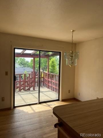 11318 Clermont Dr, Thornton, CO 80233 - unfurnished dining area featuring healthy amount of natural light, wood finished floors, and a chandelier