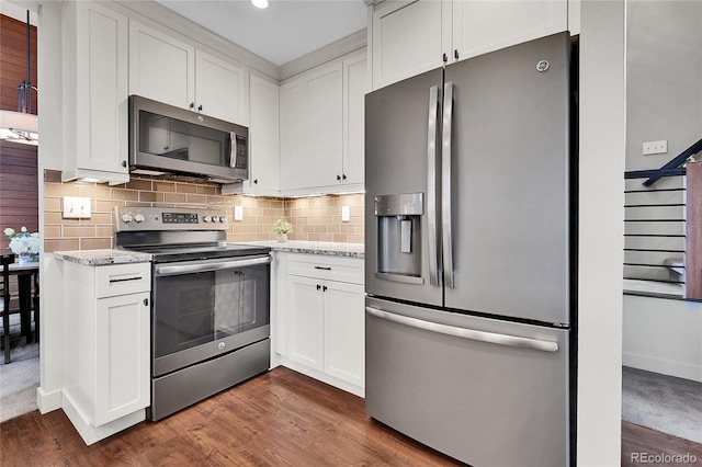 30334 Roan Dr, Evergreen, CO 80439 - kitchen with stainless steel appliances, dark wood finished floors, light stone countertops, white cabinets, and recessed lighting