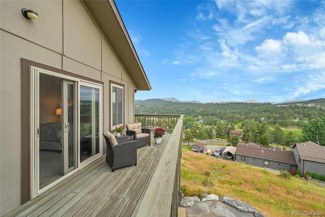 30334 Roan Dr, Evergreen, CO 80439 - wooden terrace featuring a mountain view and a view of trees