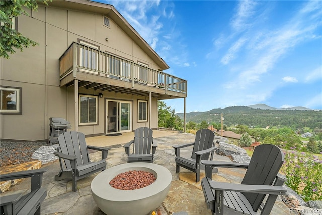 30334 Roan Dr, Evergreen, CO 80439 - patio / terrace with a fire pit, a mountain view, a patio area, and a grill