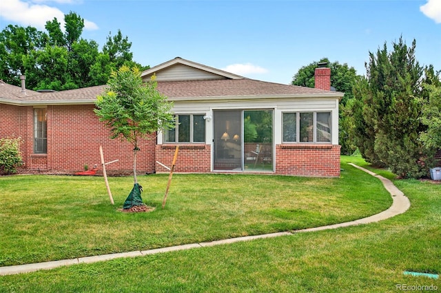 2800 S University Blvd Unit 174, Denver, CO 80210 - rear view of house featuring brick siding, a chimney, a yard, and a shingled roof