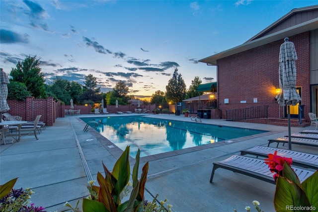 2800 S University Blvd Unit 174, Denver, CO 80210 - pool at dusk featuring a patio area and a community pool