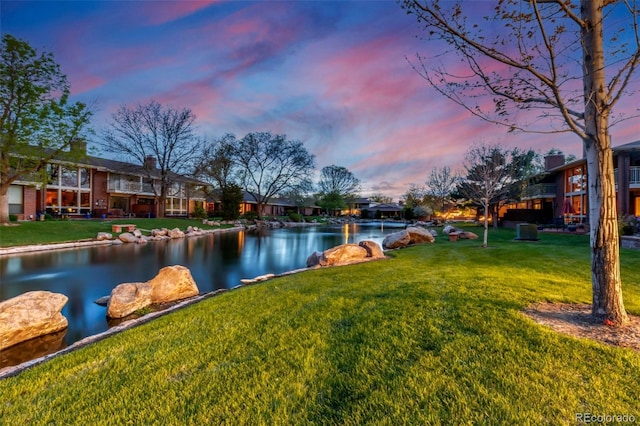 2800 S University Blvd Unit 174, Denver, CO 80210 - yard at dusk with a water view, a yard, and a residential view