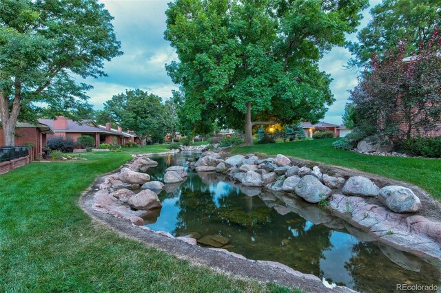 2800 S University Blvd Unit 174, Denver, CO 80210 - view of pool featuring a lawn and a garden pond