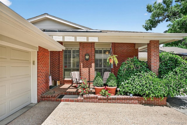 2800 S University Blvd Unit 174, Denver, CO 80210 - entrance to property featuring brick siding, covered porch, and an attached garage