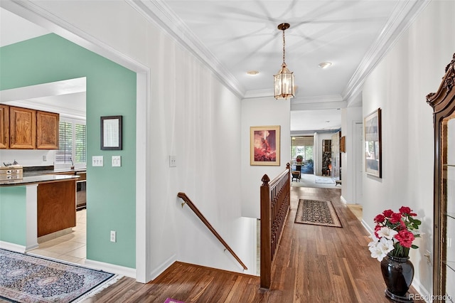 2800 S University Blvd Unit 174, Denver, CO 80210 - hall featuring an upstairs landing, light wood-type flooring, crown molding, and a chandelier