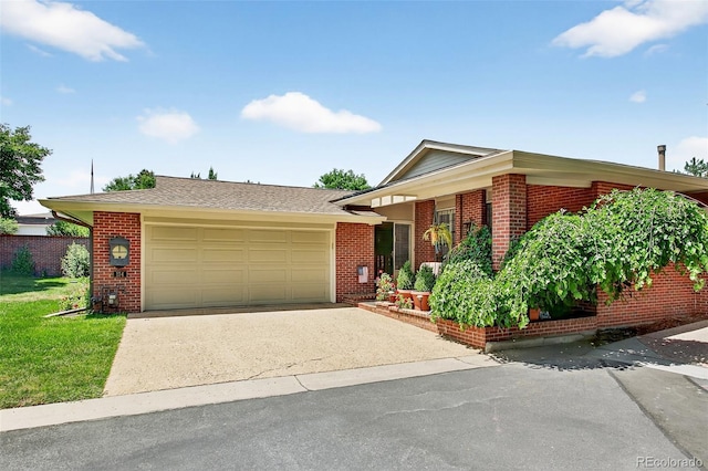 2800 S University Blvd Unit 174, Denver, CO 80210 - view of front of house featuring brick siding, an attached garage, asphalt driveway, and a front lawn