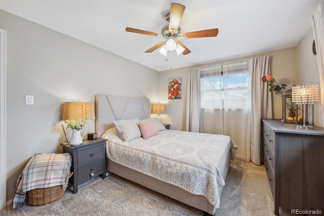 bedroom featuring light colored carpet and ceiling fan