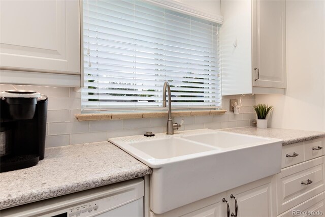 6666 S Pennsylvania St, Centennial, CO 80121 - kitchen featuring decorative backsplash, white cabinetry, dishwasher, and light countertops
