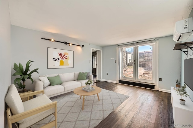 living room featuring dark hardwood / wood-style floors and a wall mounted AC