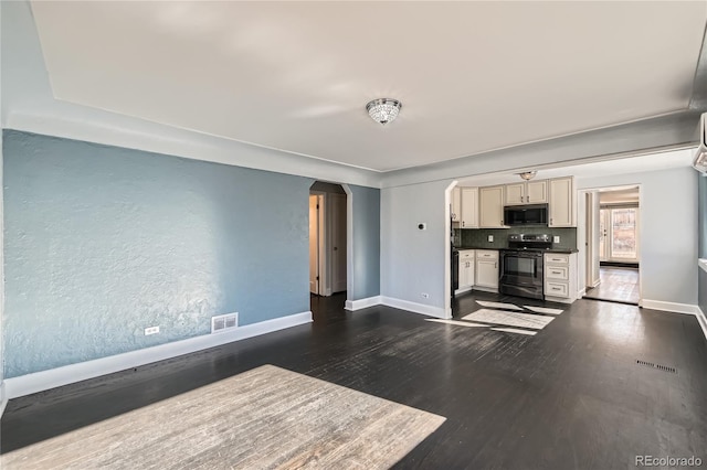 unfurnished living room with dark wood-type flooring