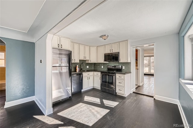 kitchen featuring sink, dark hardwood / wood-style floors, backsplash, and appliances with stainless steel finishes