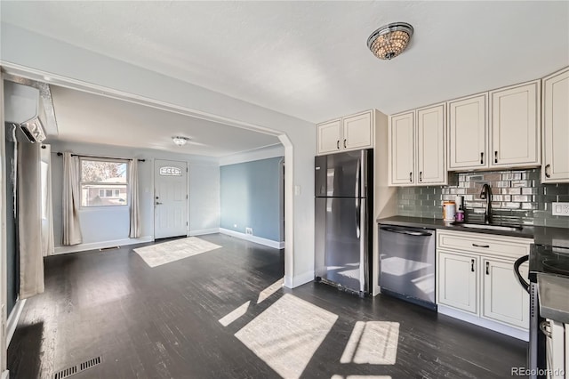 kitchen with sink, dark hardwood / wood-style flooring, tasteful backsplash, and appliances with stainless steel finishes