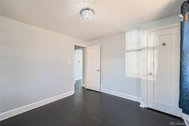 spare room with dark hardwood / wood-style flooring