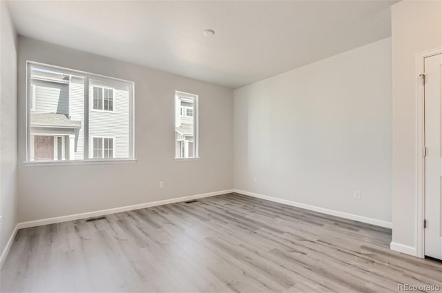 spare room with light wood-type flooring