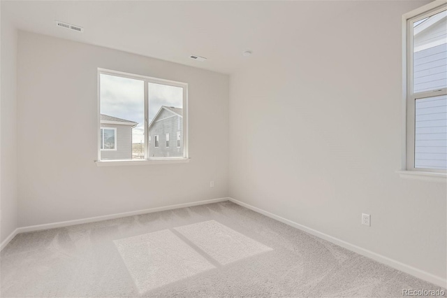 unfurnished room with light colored carpet