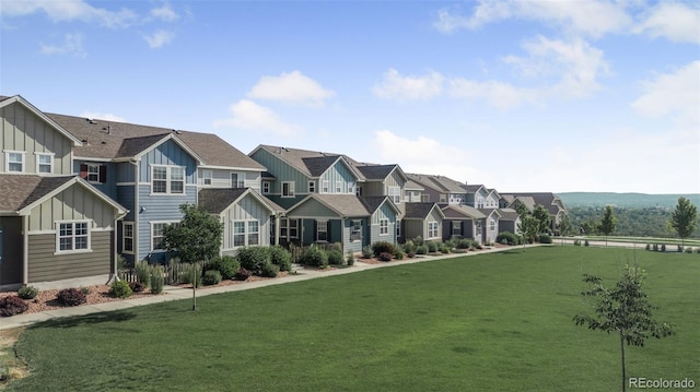 44 S Olympian Dr, Colorado Springs, CO 80905 - townhome / multi-family property featuring board and batten siding, a residential view, and a front yard