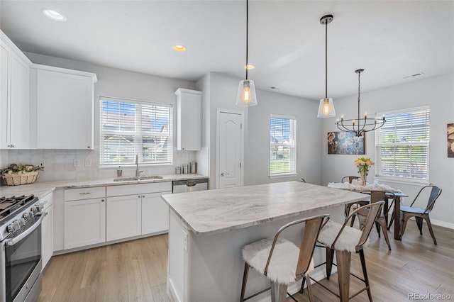 44 S Olympian Dr, Colorado Springs, CO 80905 - kitchen featuring healthy amount of natural light, light wood-style floors, stainless steel appliances, tasteful backsplash, and recessed lighting