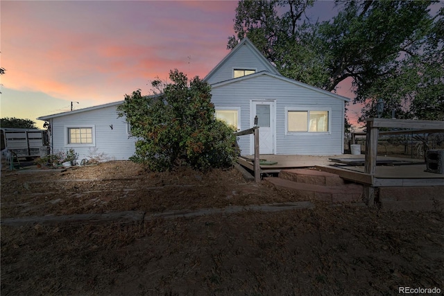 view of back house at dusk