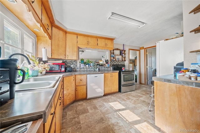 kitchen with decorative backsplash, stainless steel appliances, and sink