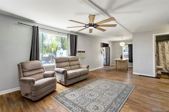 1917 E Cache La Poudre St, Colorado Springs, CO 80909 - living room featuring baseboards, a wall unit AC, a ceiling fan, and wood finished floors