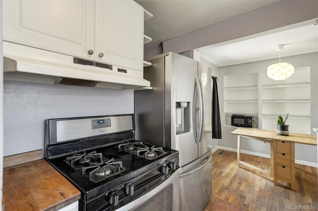 1917 E Cache La Poudre St, Colorado Springs, CO 80909 - kitchen featuring appliances with stainless steel finishes, wood-type flooring, a chandelier, under cabinet range hood, and white cabinetry
