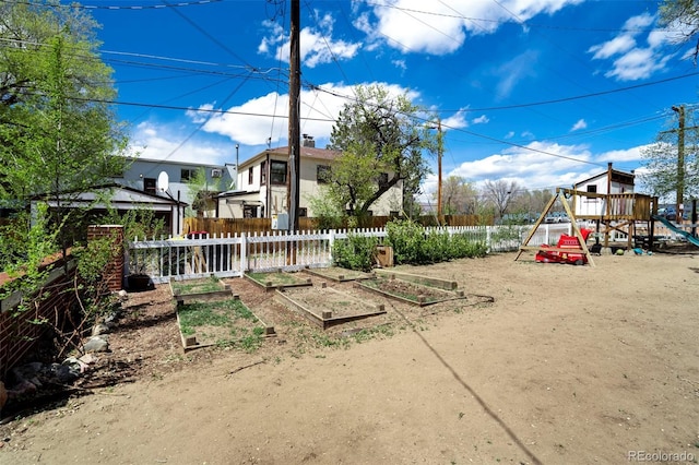 1917 E Cache La Poudre St, Colorado Springs, CO 80909 - view of yard with fence, a playground, and a vegetable garden