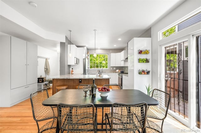 1947 King St, Denver, CO 80204 - dining room featuring light wood finished floors, plenty of natural light, and recessed lighting