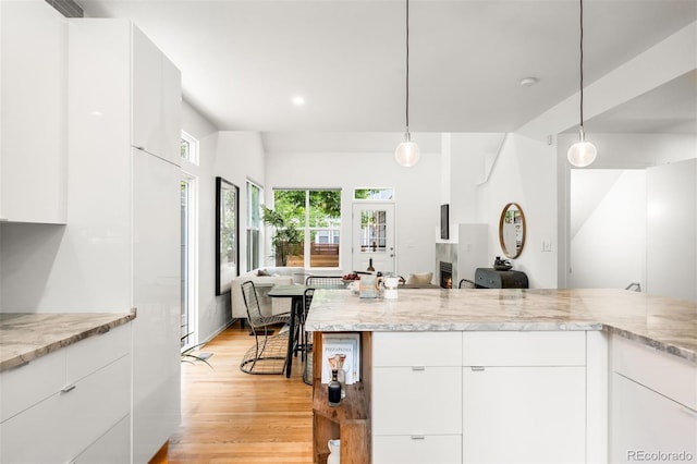 1947 King St, Denver, CO 80204 - kitchen featuring open floor plan, modern cabinets, light wood-type flooring, white cabinets, and recessed lighting