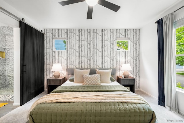 1947 King St, Denver, CO 80204 - bedroom featuring a barn door, ceiling fan, and baseboards