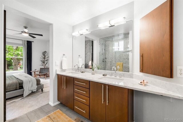 1947 King St, Denver, CO 80204 - bathroom featuring a shower stall, double vanity, ceiling fan, tile patterned floors, and connected bathroom
