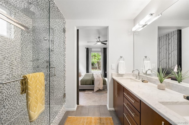 1947 King St, Denver, CO 80204 - ensuite bathroom with double vanity, a stall shower, wood finished floors, and a ceiling fan