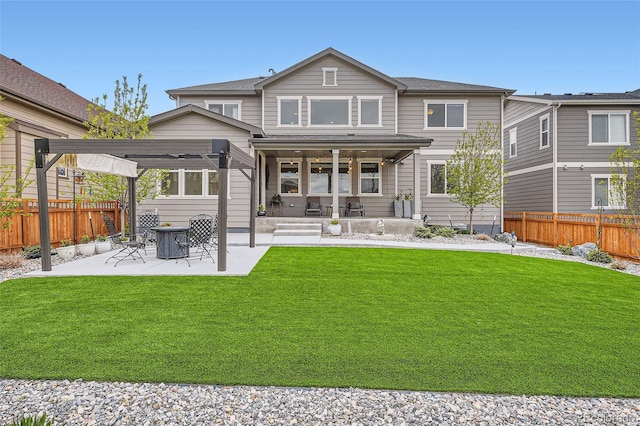 rear view of house featuring ceiling fan, a pergola, a yard, and a patio area