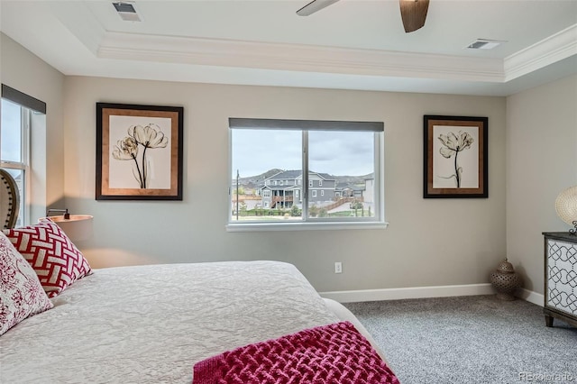 carpeted bedroom with multiple windows, ceiling fan, and ornamental molding