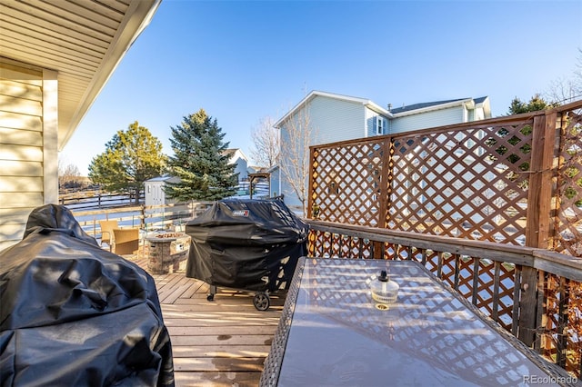 deck with a fire pit and area for grilling