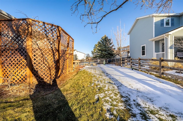 view of yard layered in snow