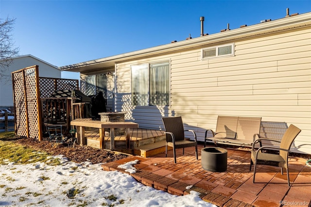 snow covered house with a patio area