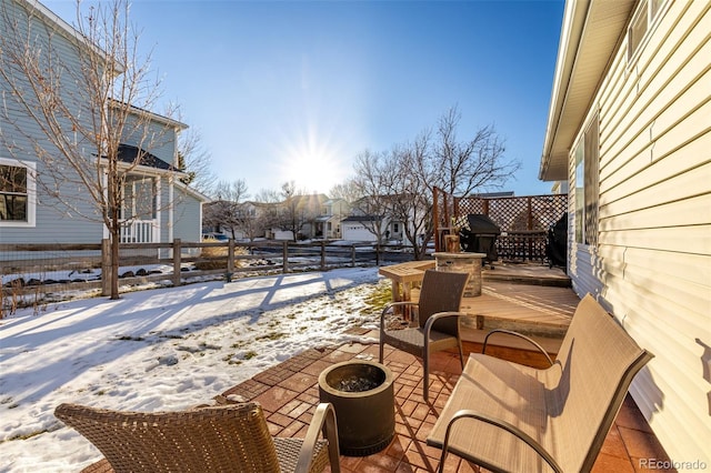 snow covered patio featuring area for grilling