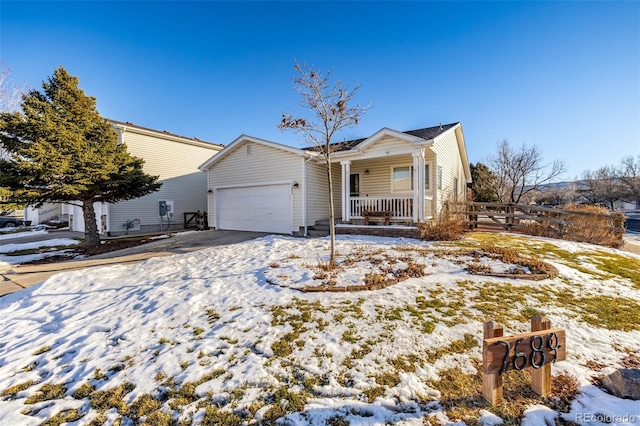 view of front of property featuring covered porch, concrete driveway, and a garage