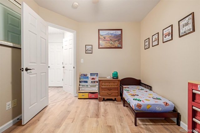 bedroom featuring light wood-type flooring and baseboards