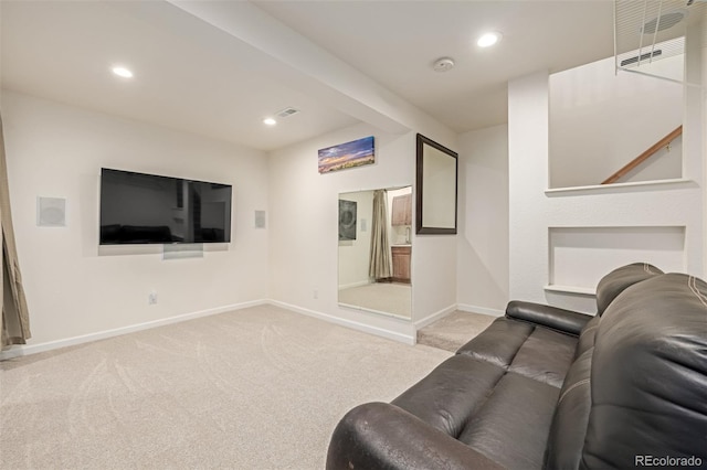 living area with recessed lighting, baseboards, and light carpet