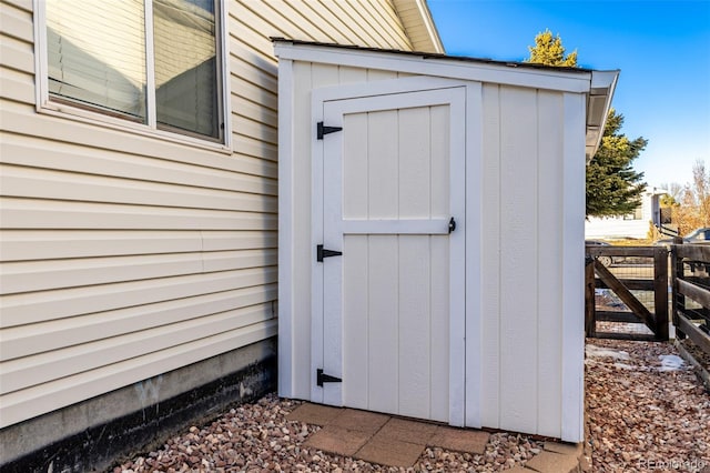 view of shed featuring fence