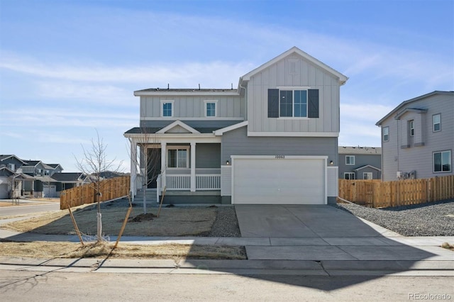 view of front of property with covered porch, concrete driveway, an attached garage, board and batten siding, and fence