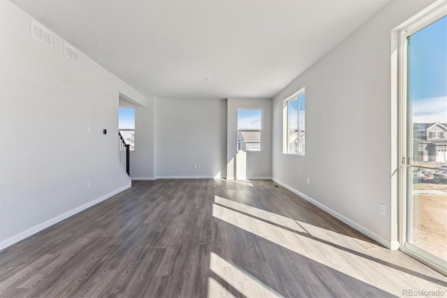 unfurnished room featuring wood finished floors and baseboards