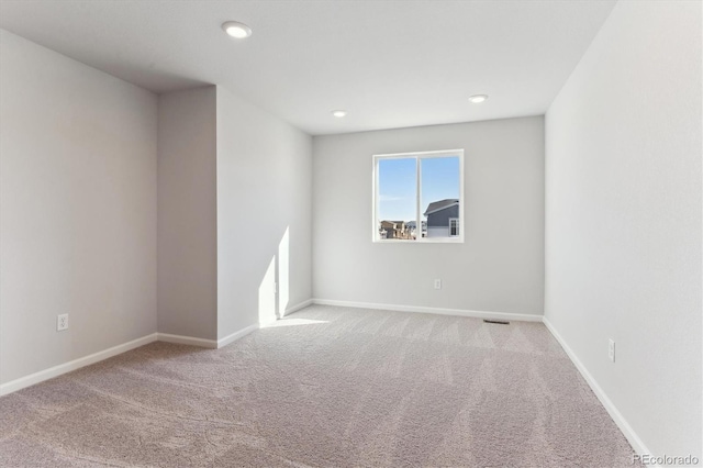 spare room with recessed lighting, carpet flooring, and baseboards