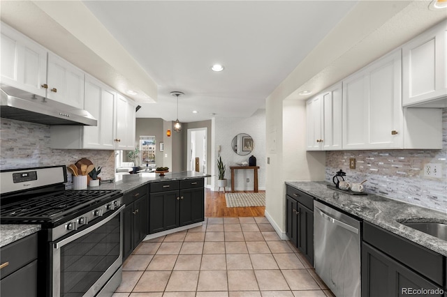 kitchen with stainless steel appliances, under cabinet range hood, white cabinetry, and recessed lighting