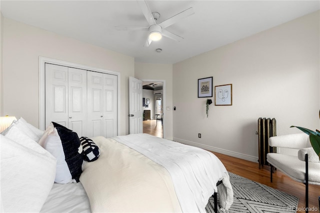 bedroom with light wood finished floors, a closet, baseboards, and a ceiling fan